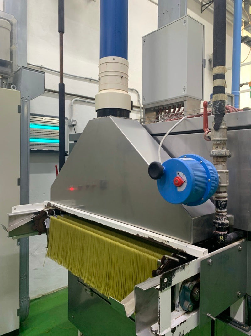 Fresh pasta coming off the press, May 2022